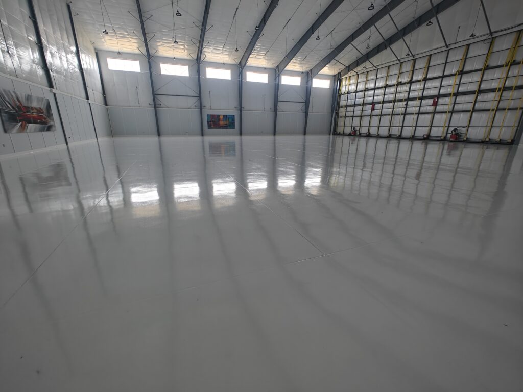 Airplane-Hangar-Concrete-Coatings-15000-sq-ft-of-white-epoxy-with-aliphatic-urethane-top-coat-Baton-Rouge-LA